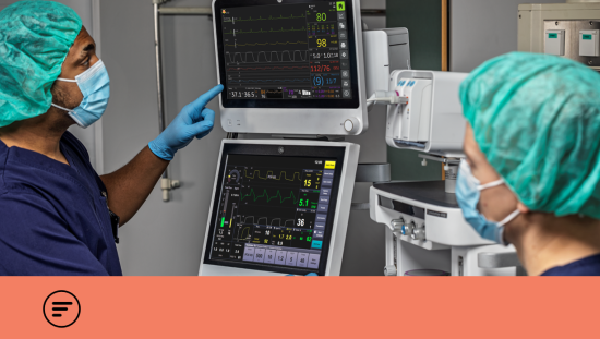 Two clinicians looking at monitor screens in the OR
